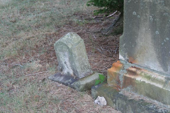 A small weathered headstone