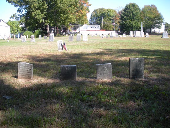 A small row of small headstones in front