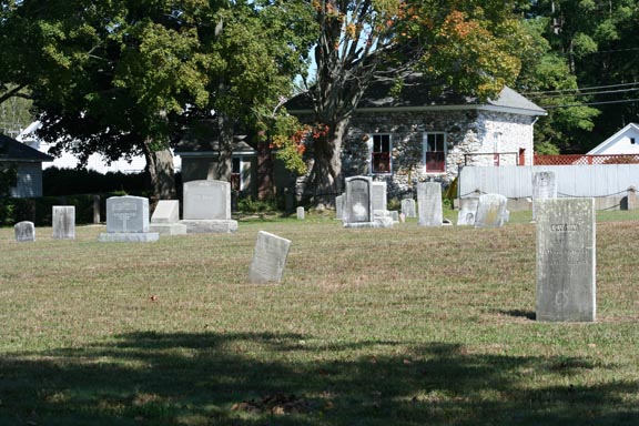 Headstones in the back, left side of the cemetery